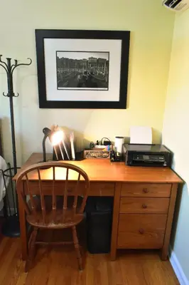 a wooden desk with a printer and a chair at 3 Bed 2 Bath, Near UAlbany & MVP Arena, Private Driveway Parking in Albany