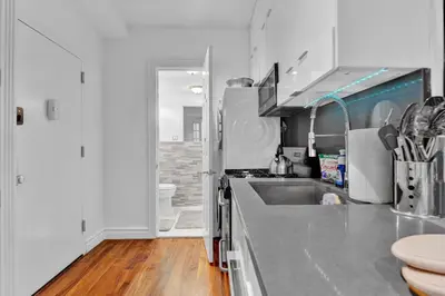 a kitchen with a sink and a counter top at Spacious SoHo 1Bedroom Unit Washer & Dryer in New York