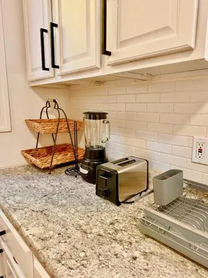 a kitchen counter with a toaster and a blender on it at Spacious 3BR Apartment - 12min Newark Airport -Near NYC & Malls in Newark
