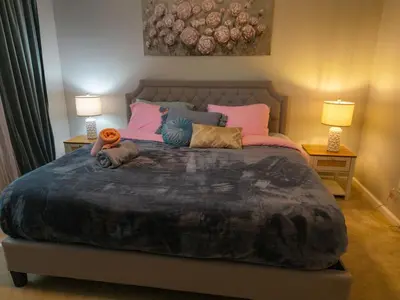 a bedroom with a large bed with a dog laying on it at Golden Deer Lodge in Tobyhanna