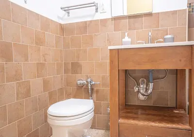 a bathroom with a toilet and a sink at Inviting 2Bd Upper East Side Stay with Backyard in New York
