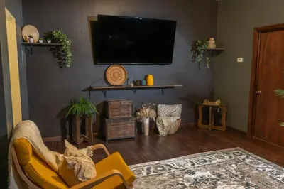 a living room with a couch and a tv at The Sicilian at Elm City Flats in New Haven