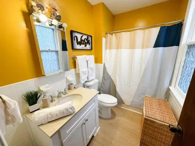 a bathroom with a sink and a toilet and a shower at The Sicilian at Elm City Flats in New Haven