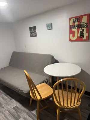 a living room with a couch and a table and chairs at Private Basement near NYC and NJ attractions in East Orange