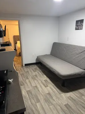 a living room with a couch in a room at Private Basement near NYC and NJ attractions in East Orange