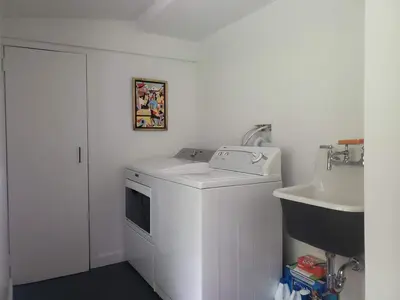 a white laundry room with a washer and a sink at Gunn Brook Mountain House in Cornwall