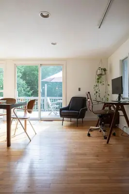 a living room with a table and chairs at Gunn Brook Mountain House in Cornwall