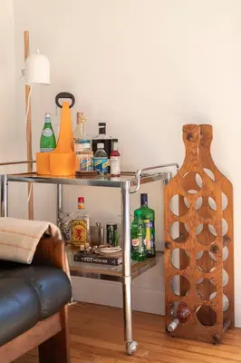 a table with a shelf with bottles and a vase at Gunn Brook Mountain House in Cornwall