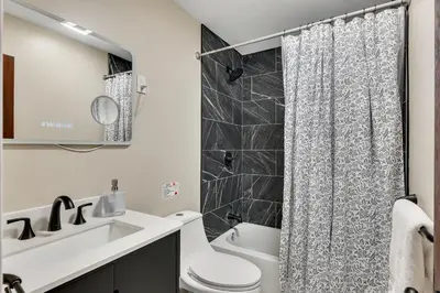 a bathroom with a toilet and a sink and a shower at Luxury Mountain Getaway - 6 bed, 3 bath, hot-tub, fire-pit, game-room in Hunter