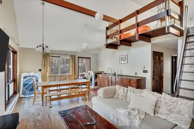 a living room with a couch and a table at Luxury Mountain Getaway - 6 bed, 3 bath, hot-tub, fire-pit, game-room in Hunter