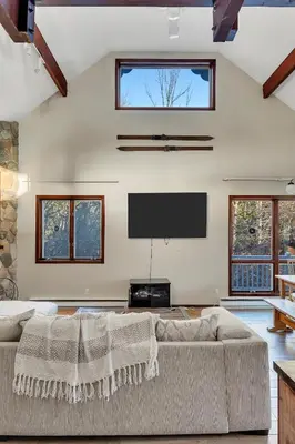 a living room with a large couch and a flat screen tv at Luxury Mountain Getaway - 6 bed, 3 bath, hot-tub, fire-pit, game-room in Hunter