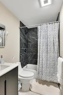 a bathroom with a toilet and a shower curtain at Luxury Mountain Getaway - 6 bed, 3 bath, hot-tub, fire-pit, game-room in Hunter