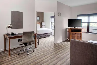 a hotel room with a bed and a desk with a computer at Hyatt House Parsippany East in Parsippany