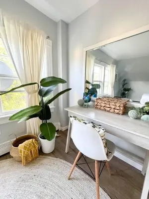 a room with a mirror and a table and a plant at The Nest At Elm City Flats in New Haven