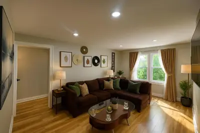 a living room with a couch and a table at 2 BR Apt|15 Min to NYC|Book Today in North Bergen