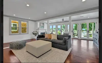 a living room with a couch and a table at Charming Home on Esopus Creek in Saugerties