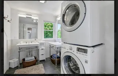a washing machine in a bathroom with a sink at Charming Home on Esopus Creek in Saugerties