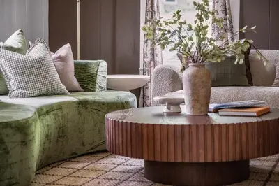 a living room with a couch and a table with a vase at Hudson Valley Hot Tub Sauna Fire Pit Games in Hudson
