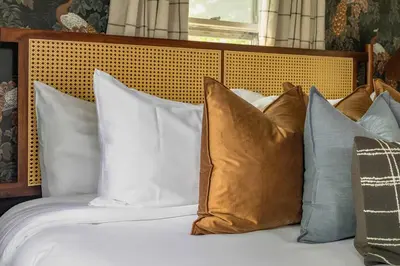 a bed with a bunch of pillows on it at Hudson Valley Hot Tub Sauna Fire Pit Games in Hudson