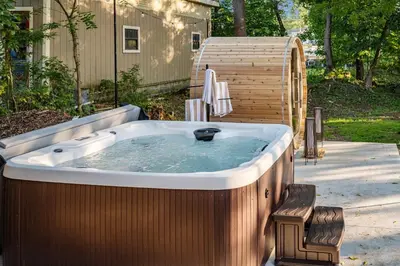 a jacuzzi tub with a chair in a yard at Hudson Valley Hot Tub Sauna Fire Pit Games in Hudson