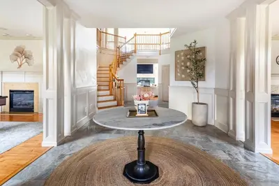 a living room with a table in the middle at Rhinebrook Estate 8 Bed 11 Bath Sleeps 20 in Hyde Park