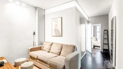a living room with a couch and a table at 2 Bedroom Apartment in Midtown Manhattan - Near NYC Icons! in New York