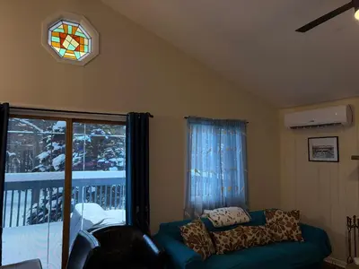 a living room with a couch and a window at Evergreen Escapes 4 BR with Game Room, Firepit near Kalahari and Camelback in Long Pond