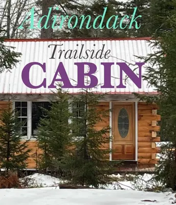 a log cabin in the snow with a sign that reads reload translate cabin at Adirondack Trailside Cabin in Caroga Lake