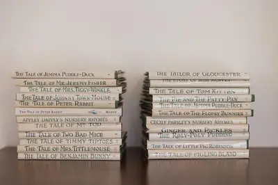 two stacks of books sitting on a table at Brand New Barn House in Stockbridge