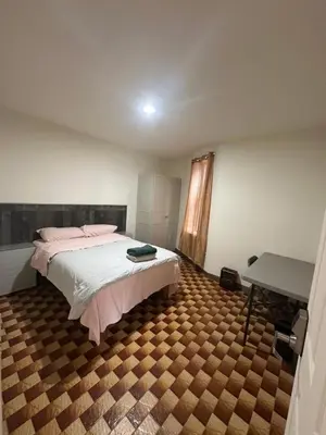 a bedroom with a bed and a table in it at Al Demashqi in New York