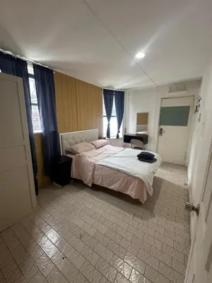 a bedroom with a large bed in a room at Al Demashqi in New York