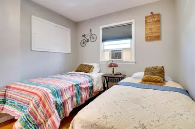 a bedroom with two beds and a bike on the wall at The Vault Your Fun Secured in Hillside
