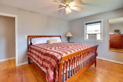 a bedroom with a bed and a ceiling fan at The Vault Your Fun Secured in Hillside