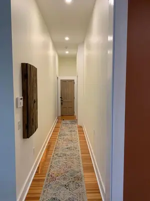 an empty hallway with a rug on the floor at Riverbend Berkshire East Basecamp in Charlemont