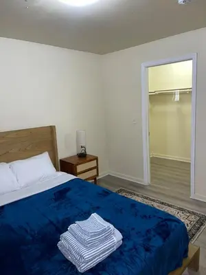 a bedroom with a blue bed with a blue blanket at Cozy 2 Bedrooms 1and half Bathrooms Near Prudential with Parking Entire Apartment in Newark