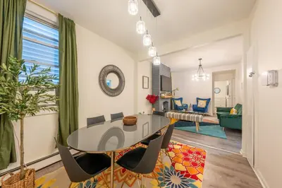 a living room with a glass table and chairs at 5BR 3BTH House, Steps to Bars, Dining, NYC Access with GameRm, Backyard with BBQ and Parking in Jersey City