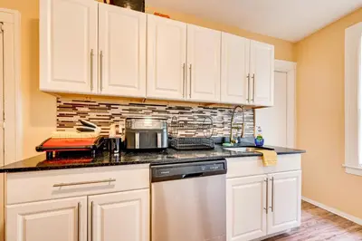a kitchen with white cabinets and a dishwasher at Convenient Hartford Condo Less Than 2 Mi to Dtwn! in Hartford