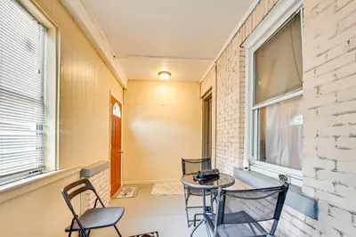 a patio with chairs and a table and a window at Convenient Hartford Condo Less Than 2 Mi to Dtwn! in Hartford