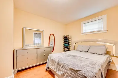 a bedroom with a bed and a dresser and a mirror at Convenient Hartford Condo Less Than 2 Mi to Dtwn! in Hartford