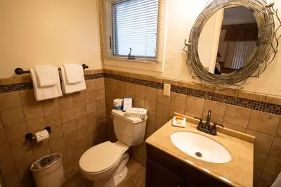 a bathroom with a toilet and a sink and a mirror at Stroudsmoor Country Inn in Stroudsburg