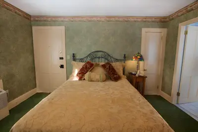 a bedroom with a large bed in a room at Stroudsmoor Country Inn in Stroudsburg