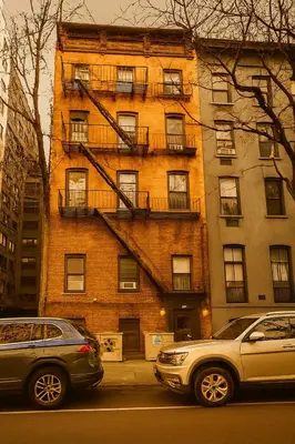 two cars parked in front of a brick building at Private Studio Apartment in Union Square in New York
