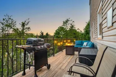 a patio with a grill and a couch on a deck at 3BR Apt Near Train Balcony Yonkers in Yonkers
