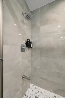 a bathroom with a shower with a glass door at 3BR Apt Near Train Balcony Yonkers in Yonkers