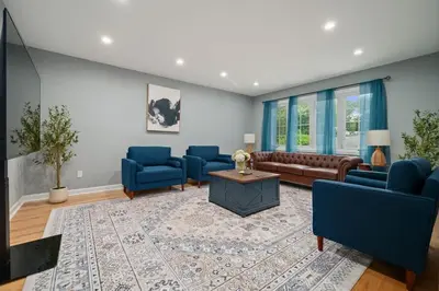 a living room with blue chairs and a couch at 3BR Apt Near Train Balcony Yonkers in Yonkers