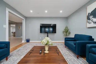 a living room with two blue couches and a coffee table at 3BR Apt Near Train Balcony Yonkers in Yonkers