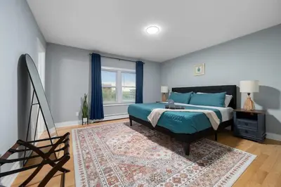 a bedroom with a bed and a rug at 3BR Apt Near Train Balcony Yonkers in Yonkers