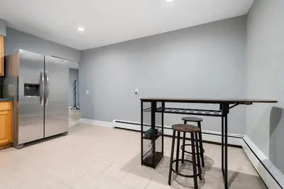 a kitchen with a counter and a refrigerator at Spacious 3BR Apt Near MetroNorth in Yonkers