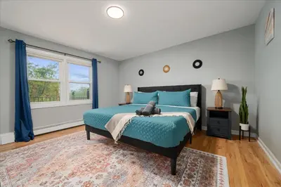 a bedroom with a bed with a teddy bear on it at 6 bdr Yonkers Home 2 Apts Balcony & Parking in Yonkers