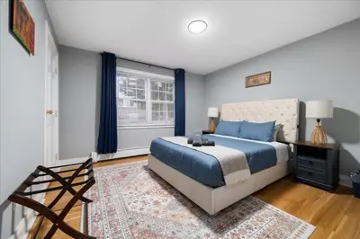 a bedroom with a king sized bed and a window at 6 bdr Yonkers Home 2 Apts Balcony & Parking in Yonkers